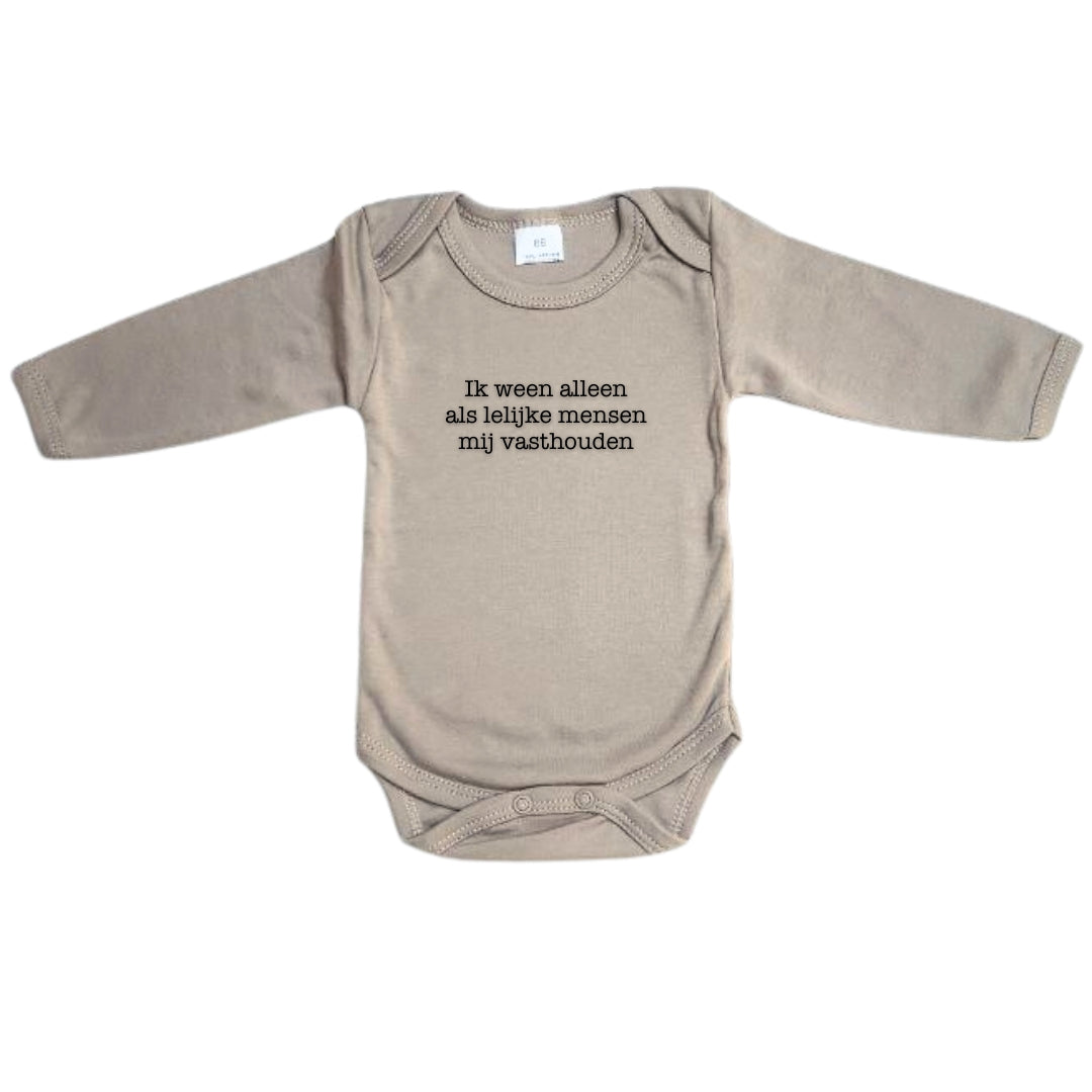 Grappige babybody met tekst “Ik ween alleen als lelijke mensen mij vasthouden”. De body heeft lange mouwen en is een leuk kerstcadeau voor ouders van jonge kindjes